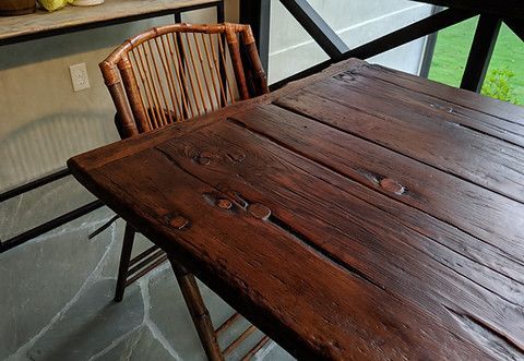 Wooden table with bamboo chair on a patio