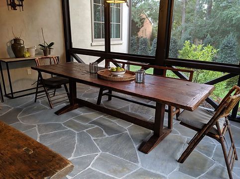 Wooden table with white cloth and flowers outside