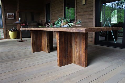 Wooden outdoor dining table on a deck