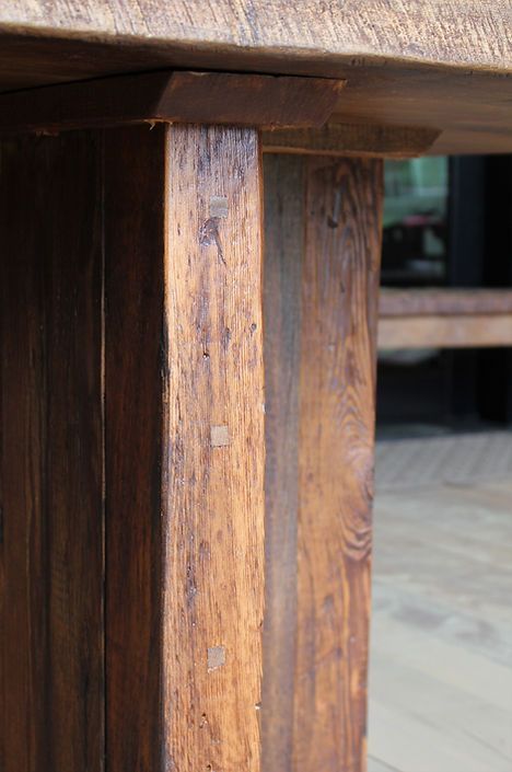Close-up of a rustic wooden table leg