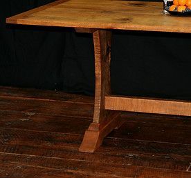 Wooden table with a curved leg on a hardwood floor