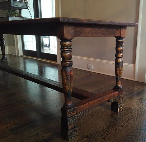 Wooden dining table with turned legs in a room with hardwood floors