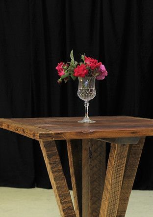 Roses in a cut glass vase on a rustic wooden table