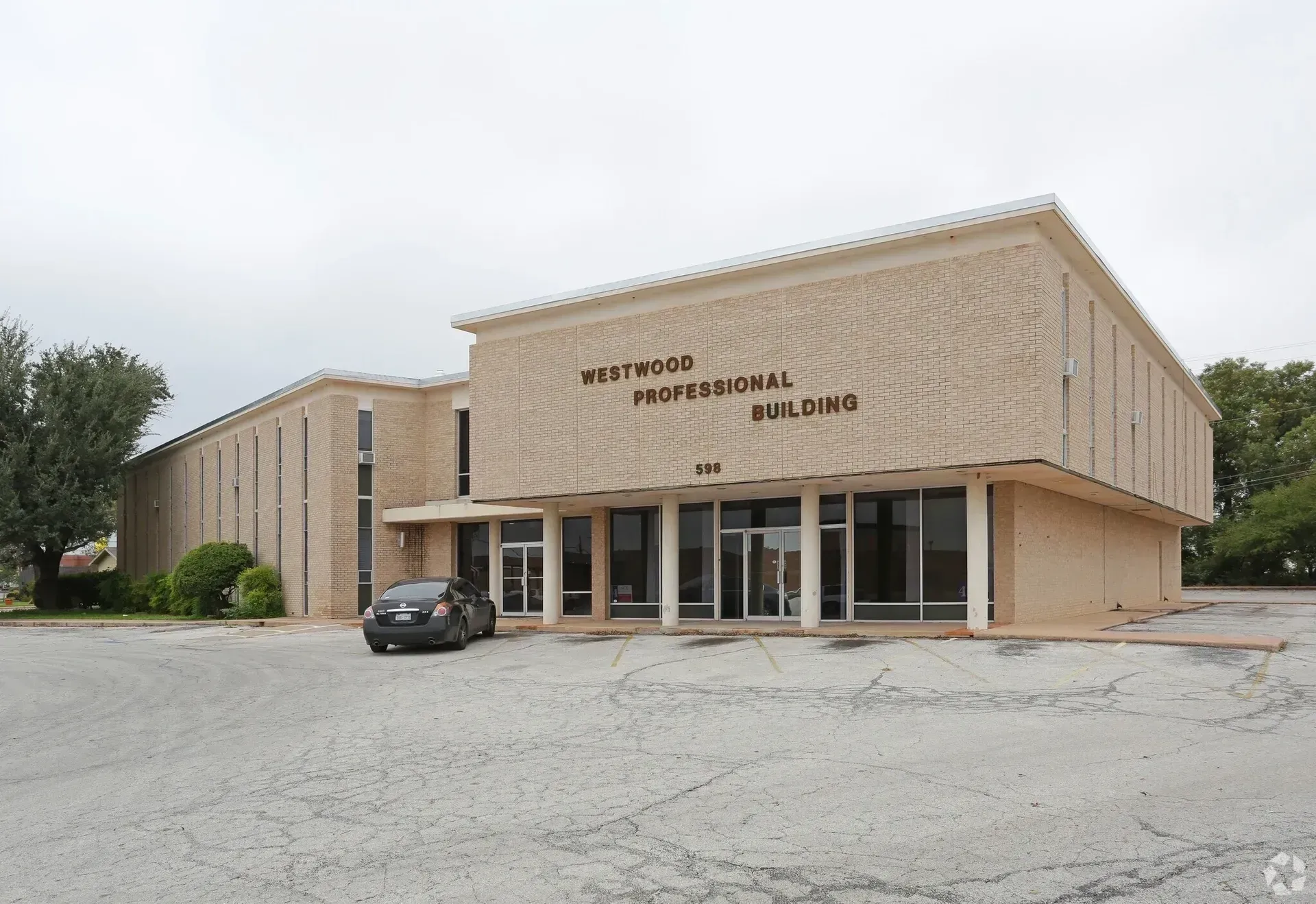 Westwood Professional Building, light brick exterior, windows, parked car.
