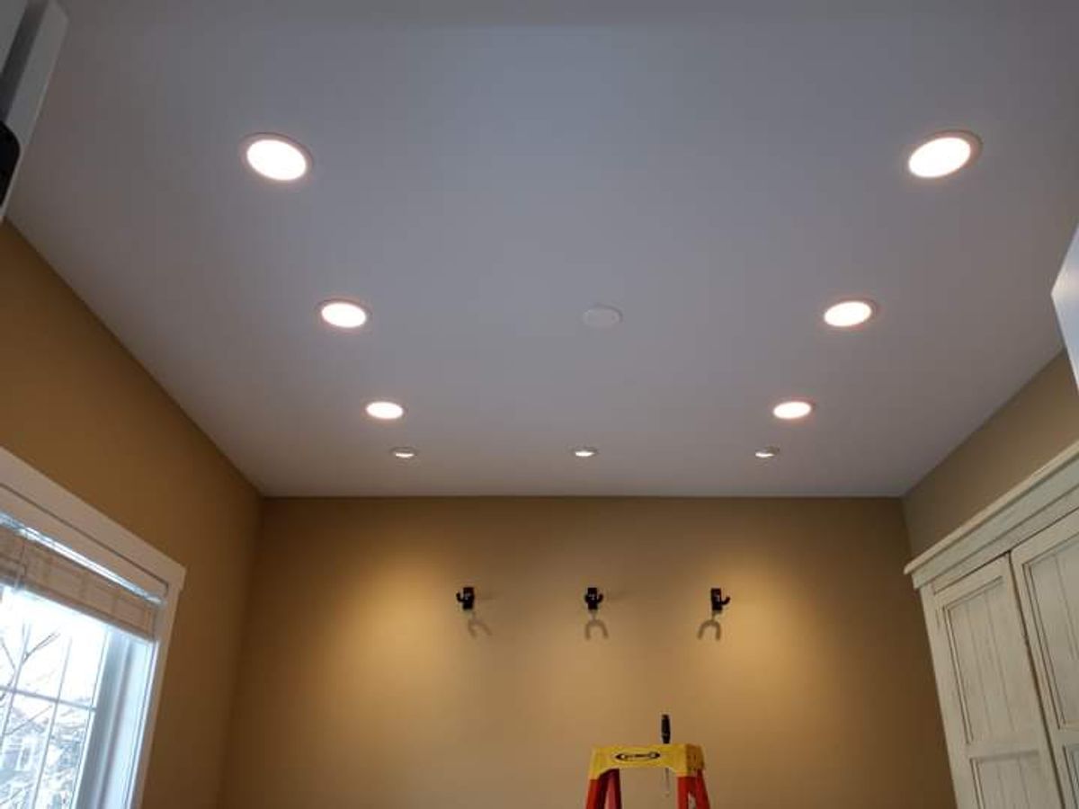 A room with a lot of lights on the ceiling