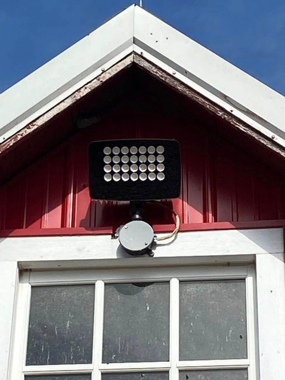 A red building with a black light on top of it
