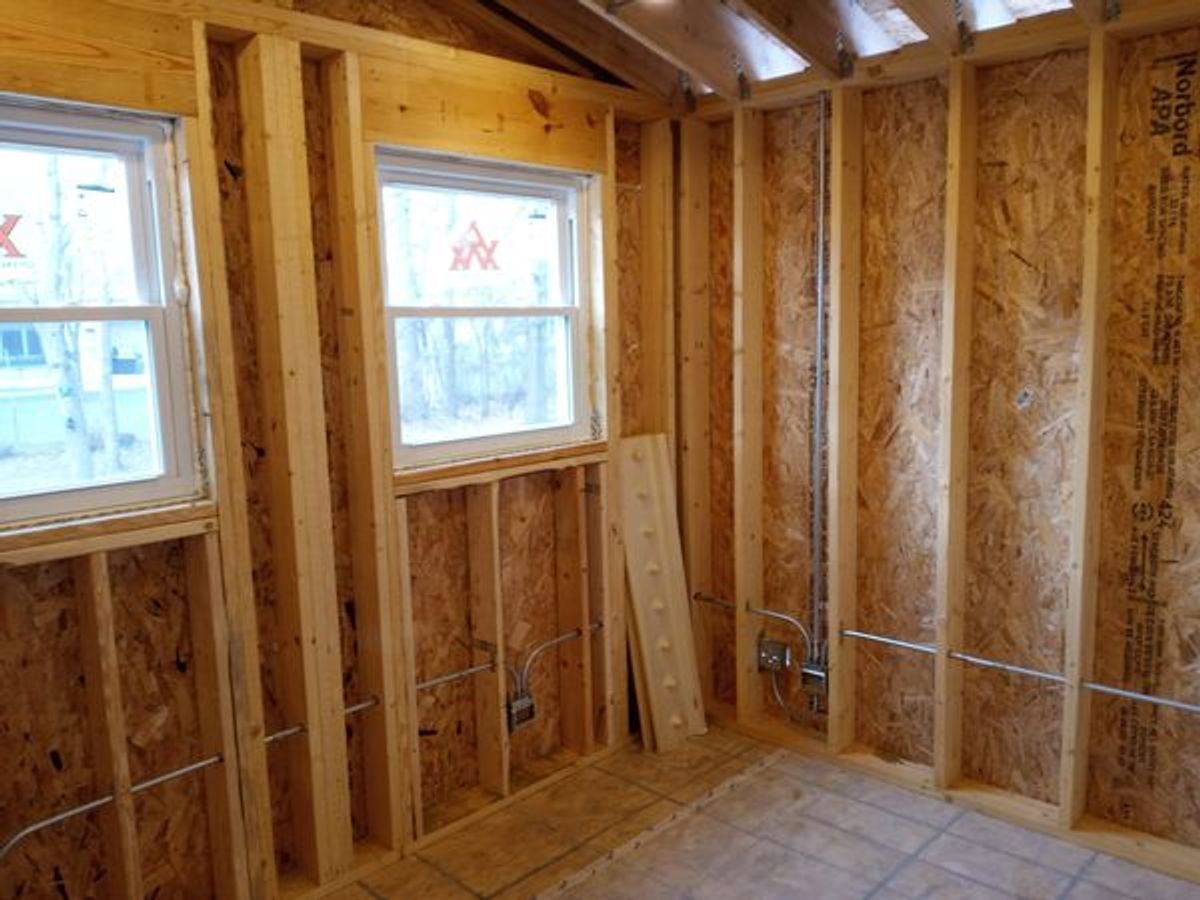 A room with wooden walls and a window in it.