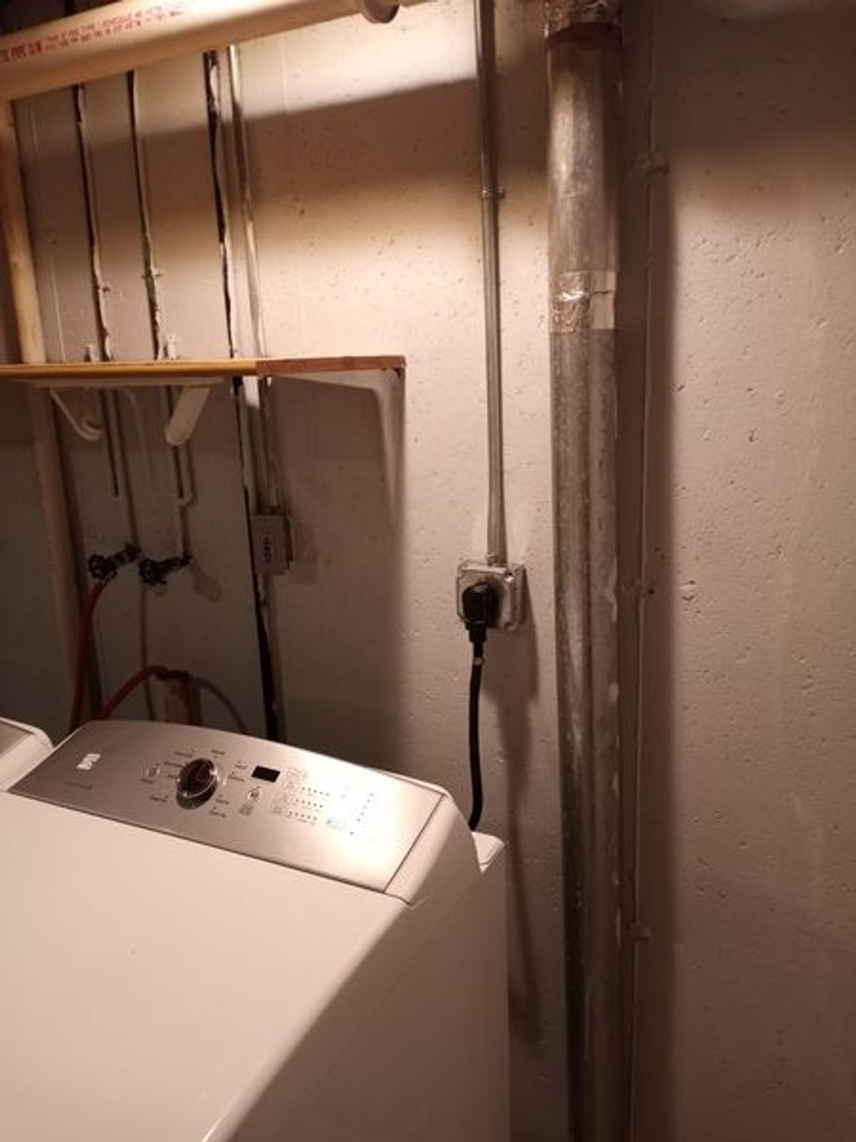 A washer and dryer are sitting next to each other in a laundry room.