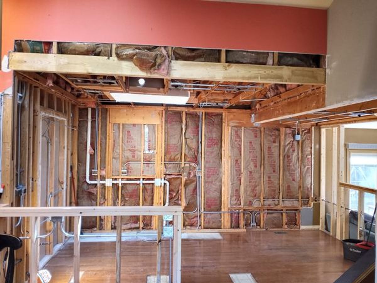 A room with a lot of wooden frames and insulation on the walls.