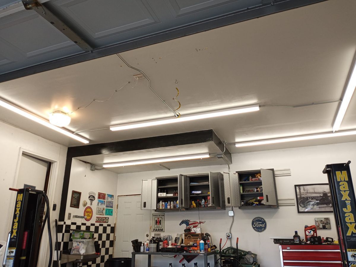 A garage with a lot of lights hanging from the ceiling.