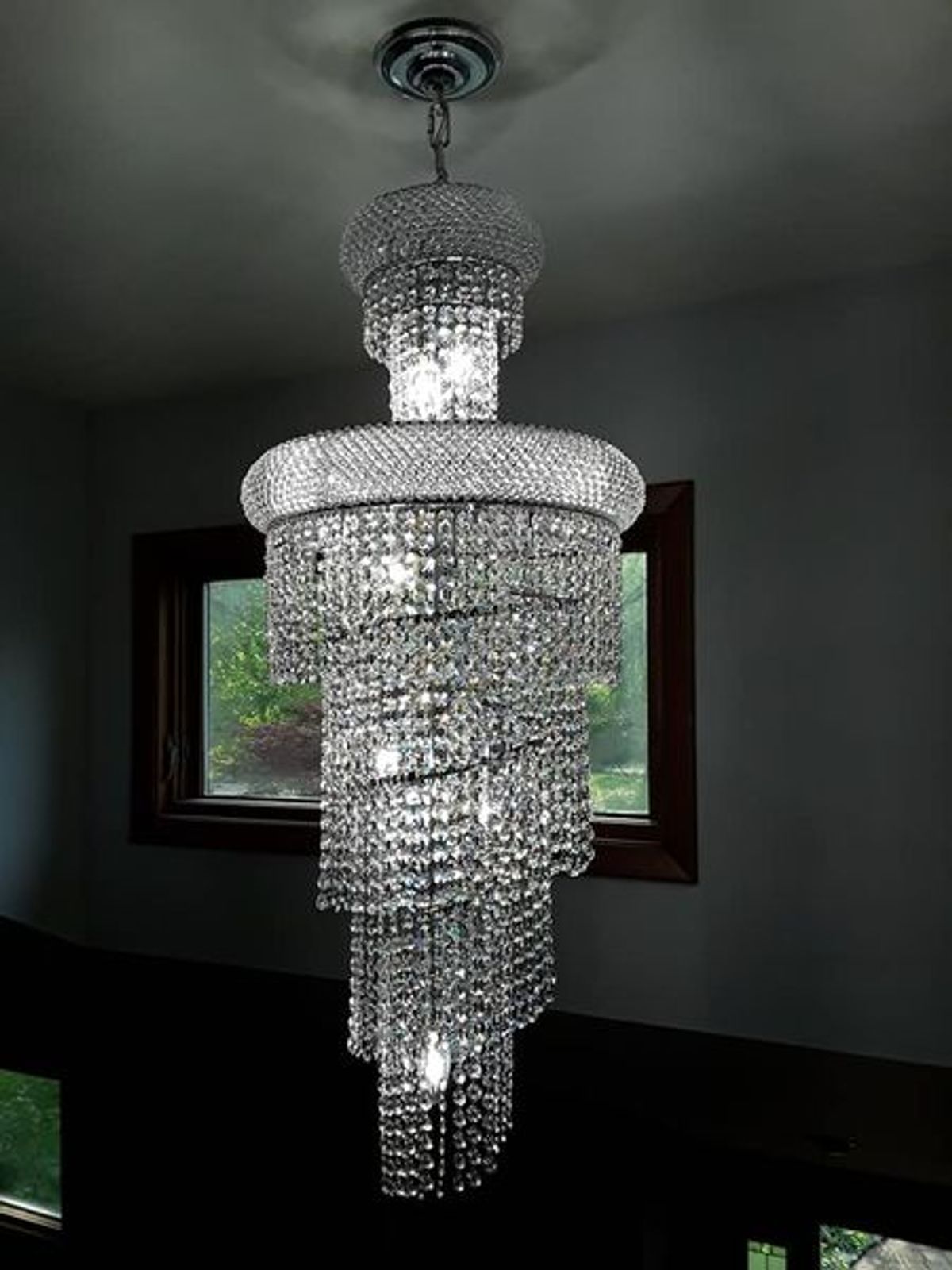 A large chandelier is hanging from the ceiling in a room.