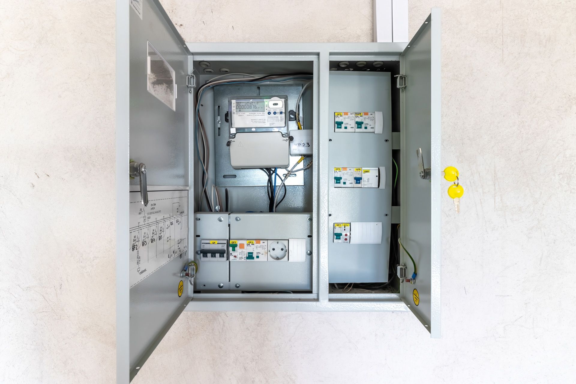 An electrical box with the doors open on a wall.