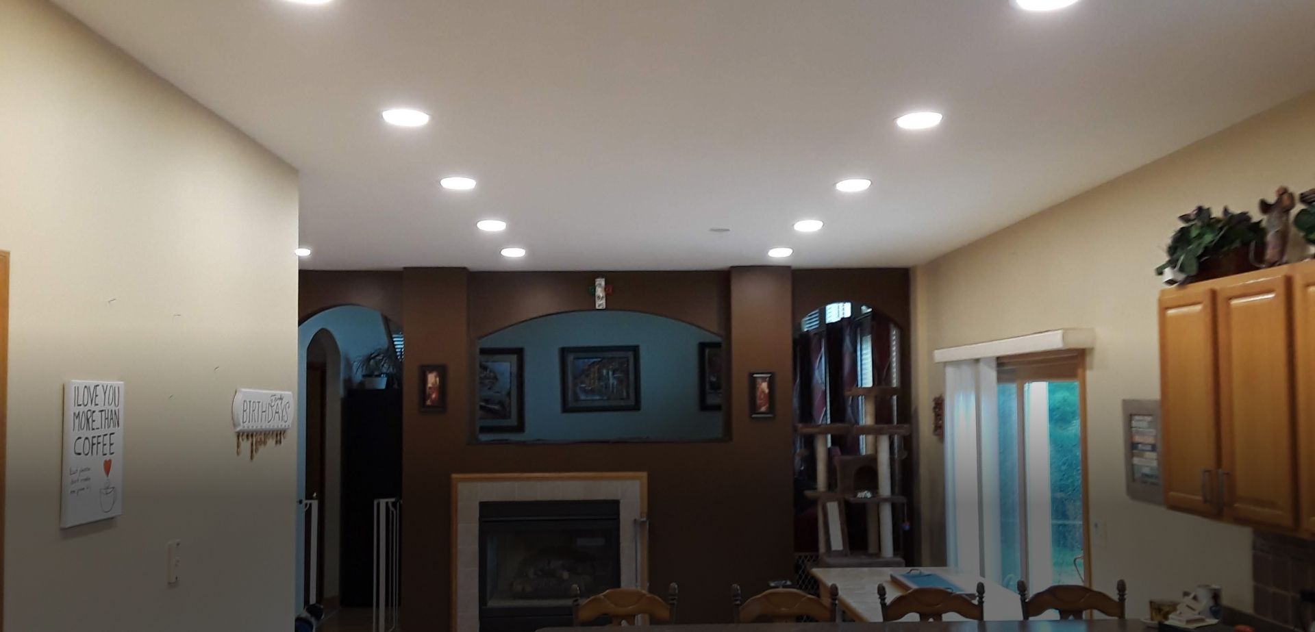 A living room with a fireplace and a table and chairs.