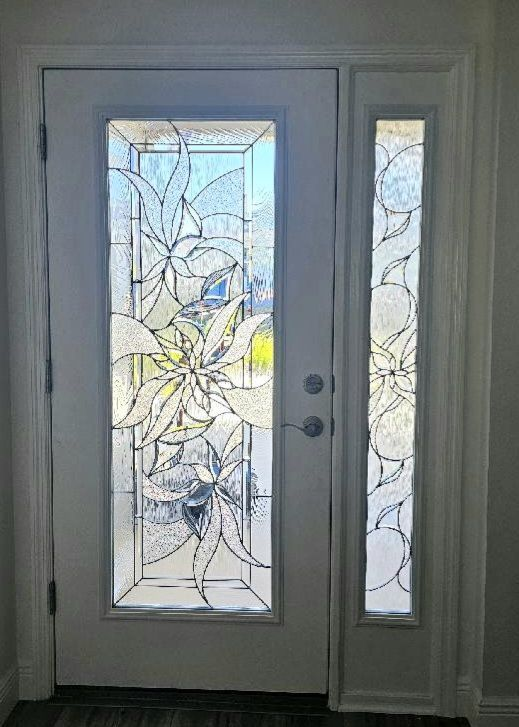 White door with decorative floral stained glass panel and sidelight.