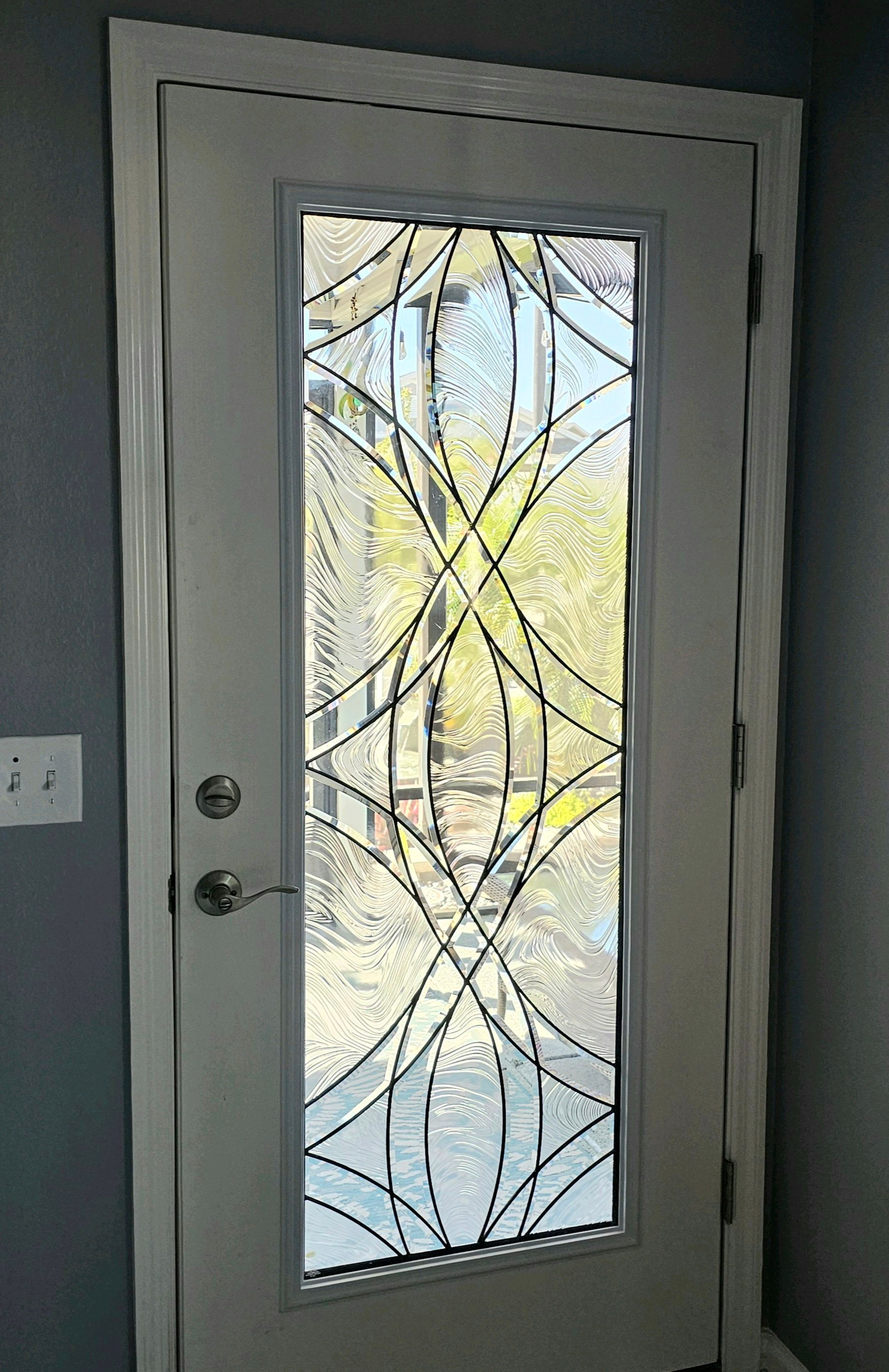 White door with a decorative glass panel.