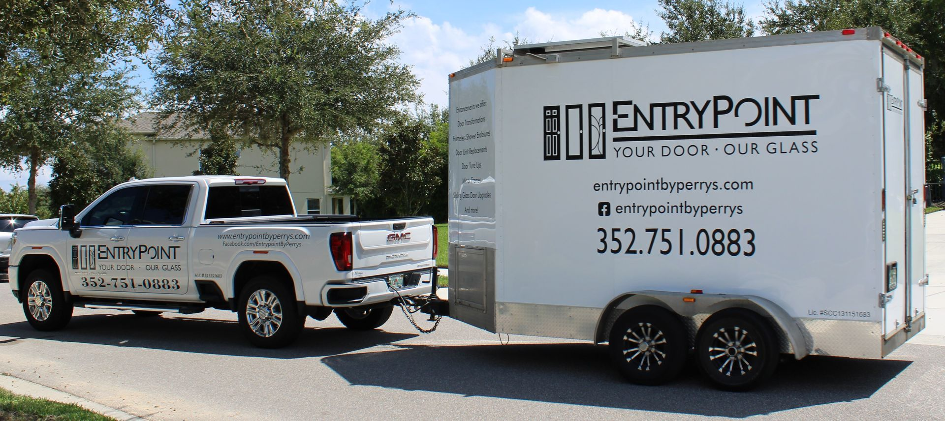 White truck towing a white trailer. Both vehicles have 