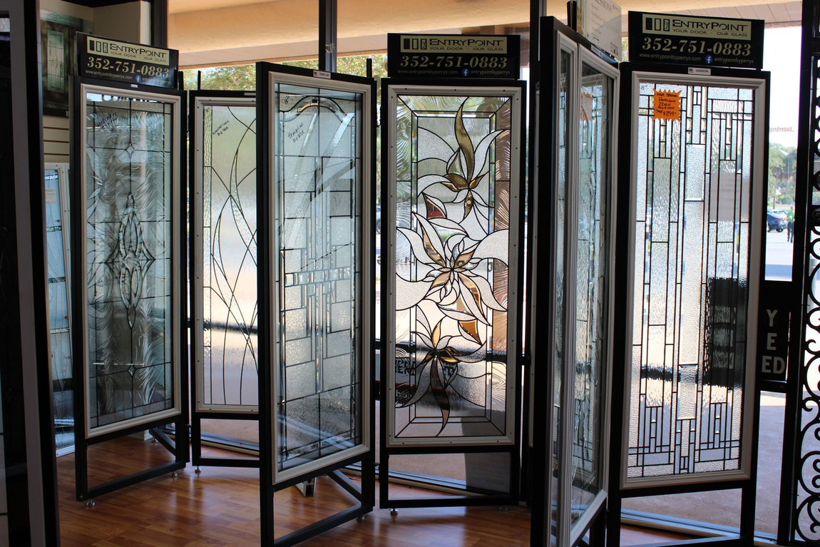 Stained glass panels on display in a store, showcasing various designs and styles.