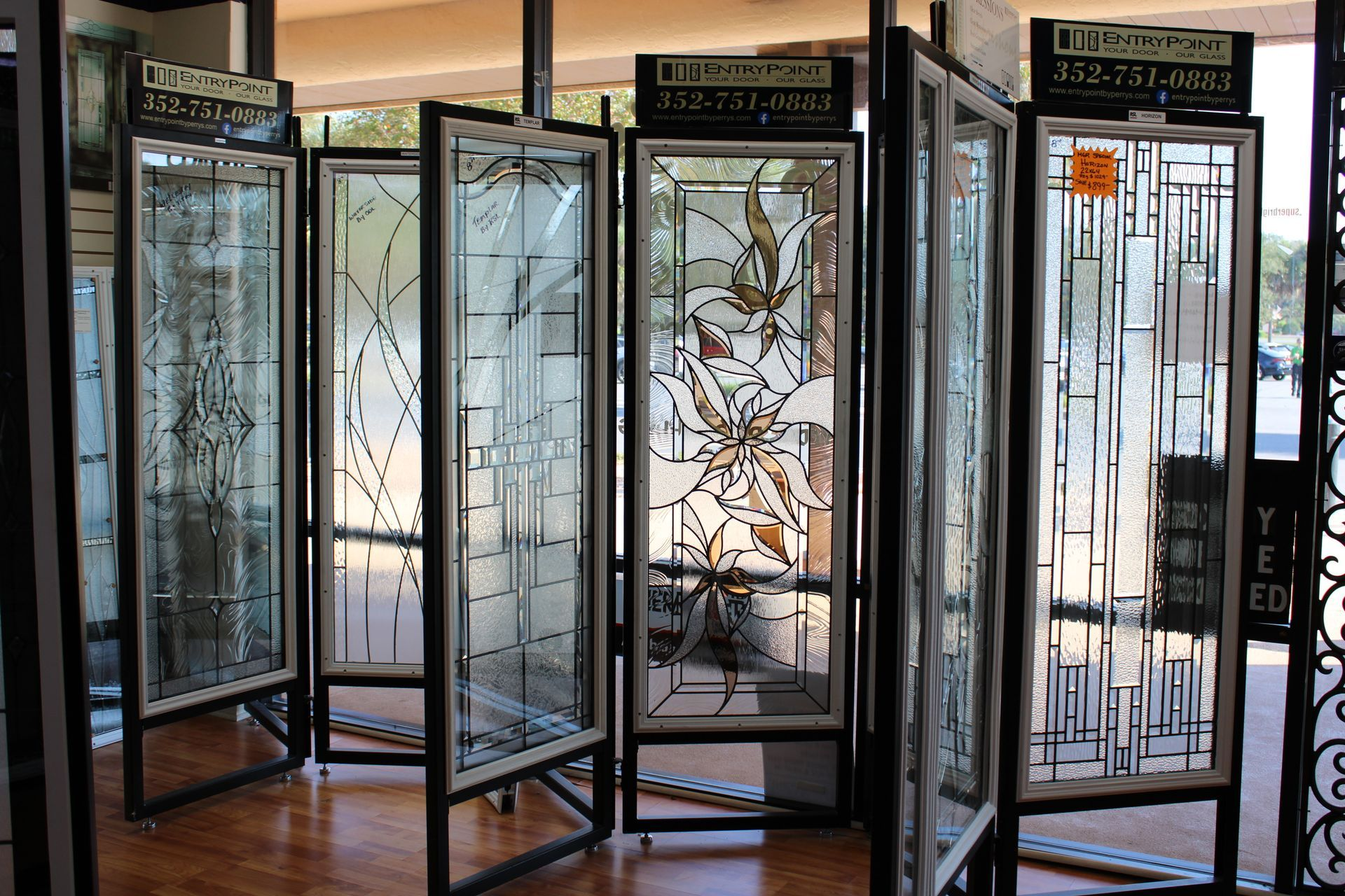 Stained glass panels on display in a store, showcasing various designs and styles.