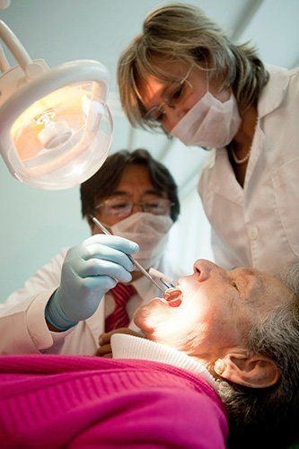 A woman who will need root canal therapy in Madison Heights, MI