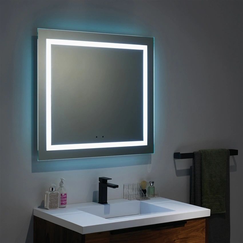 A bathroom sink with a square mirror above it