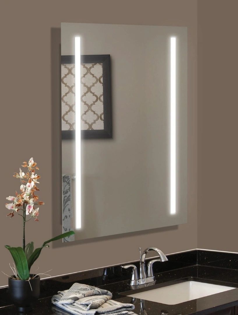 A bathroom with a sink and a mirror with lights on it