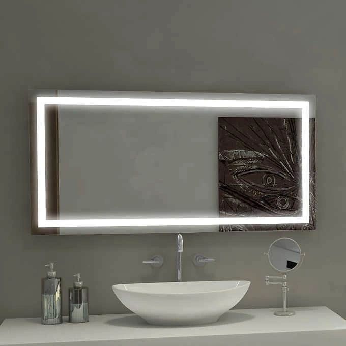 A bathroom with a sink , mirror , and lighted mirror.