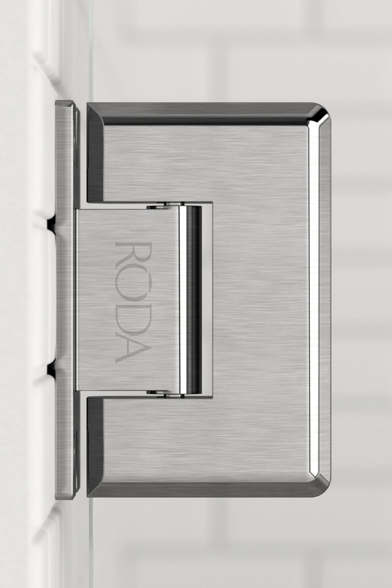 A close up of a stainless steel door hinge on a white wall.