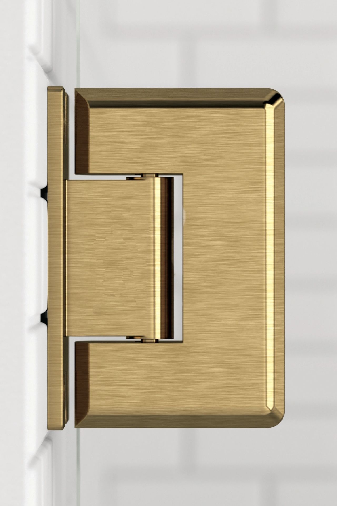 A close up of a gold door hinge on a white wall.