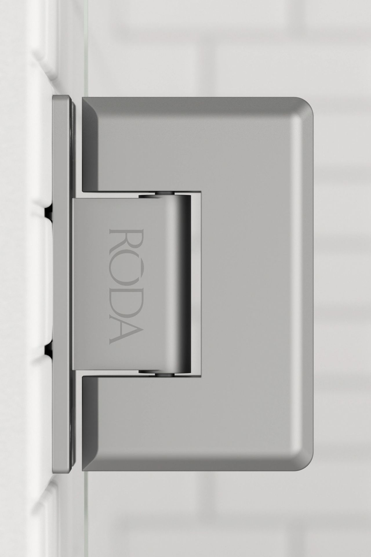 A close up of a roda door hinge on a white wall.