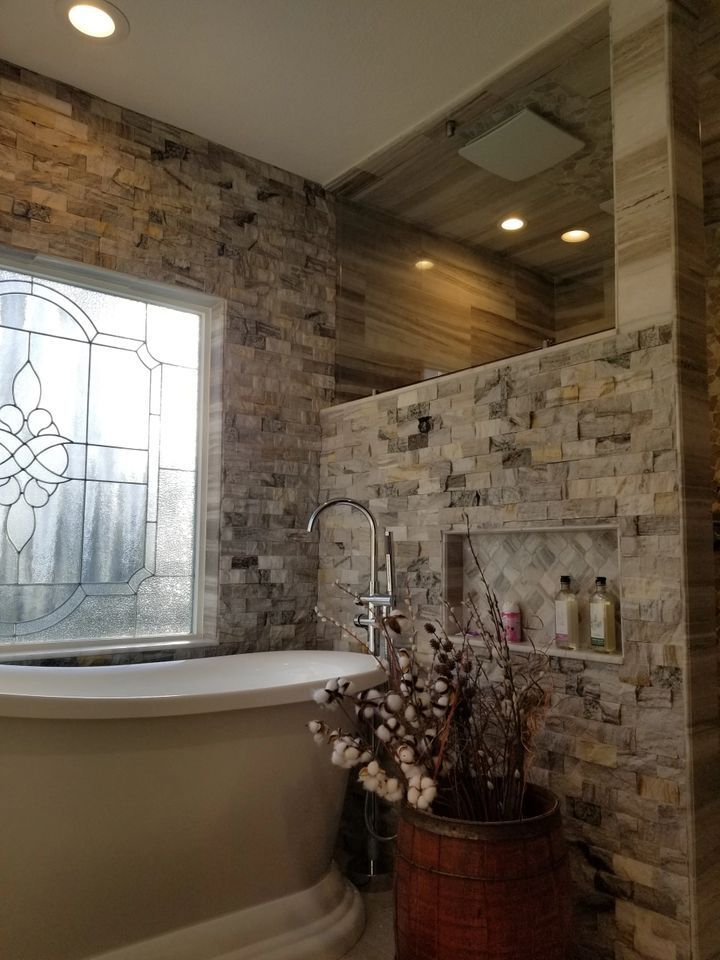 A bathroom with a tub and a stained glass window.