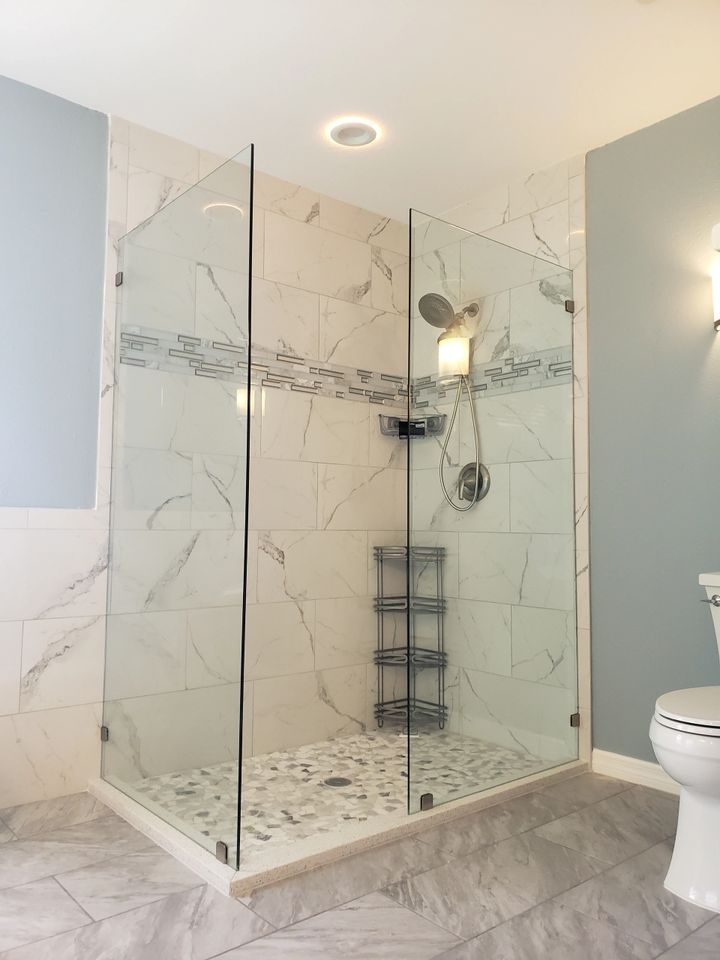 A bathroom with a walk in shower and a toilet.