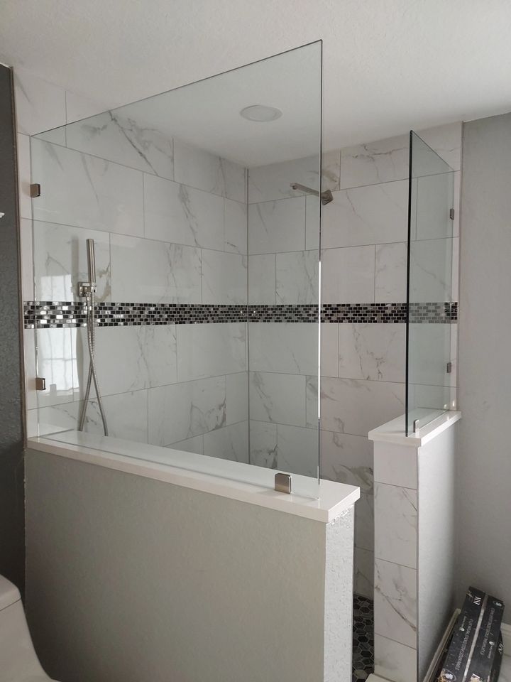 A bathroom with a walk in shower and a toilet.