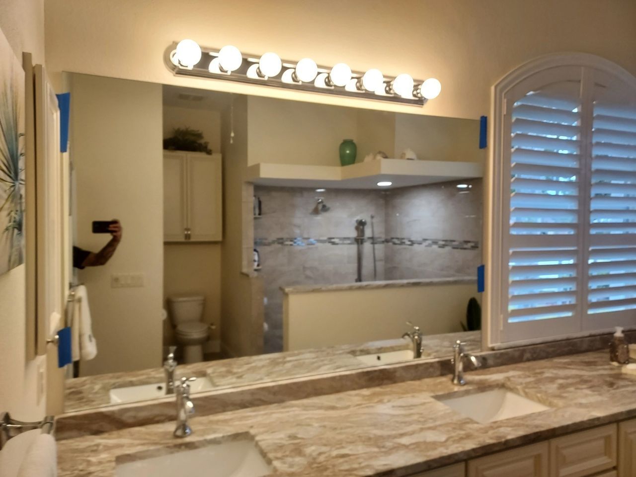 A bathroom with two sinks and a large mirror