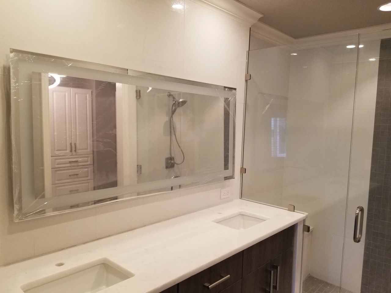 A bathroom with two sinks and a large mirror