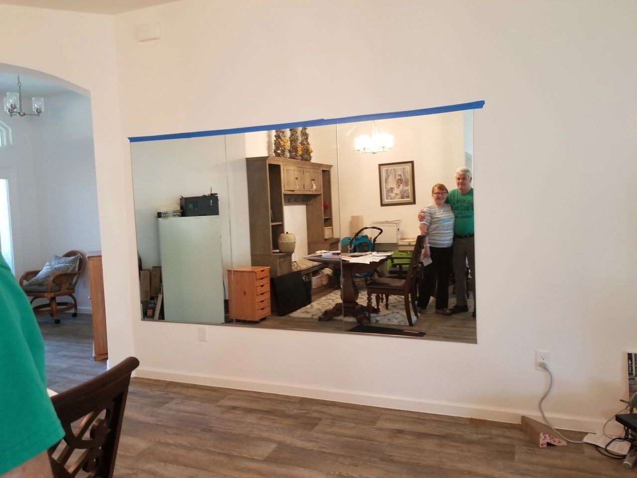 A living room with a large mirror on the wall