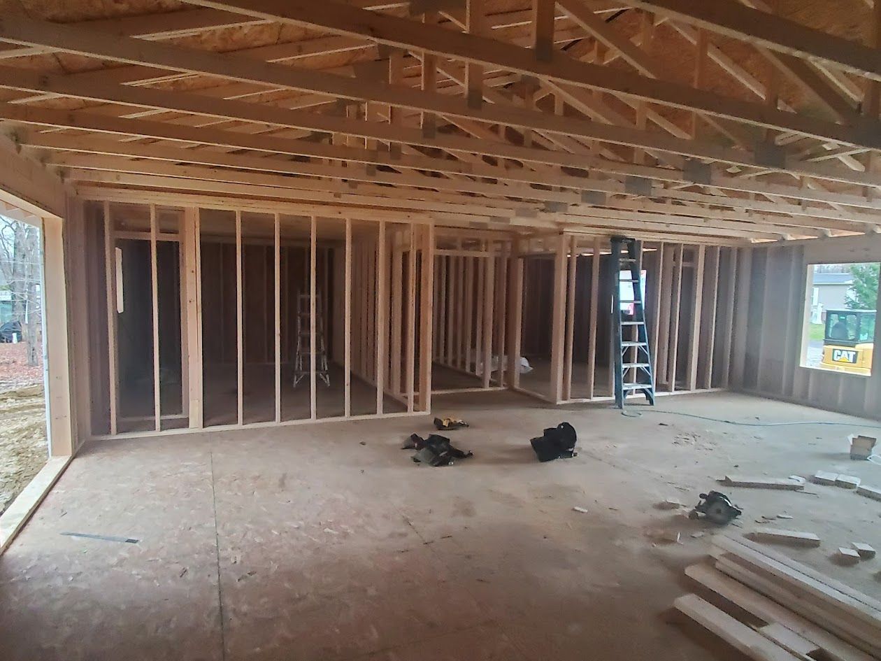 A large room with a ladder in the middle of it is being built.