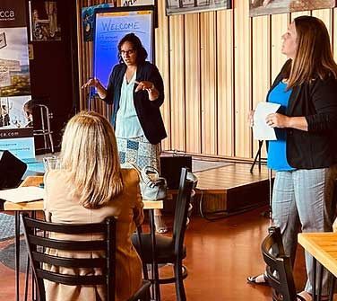 Three women at a presentation