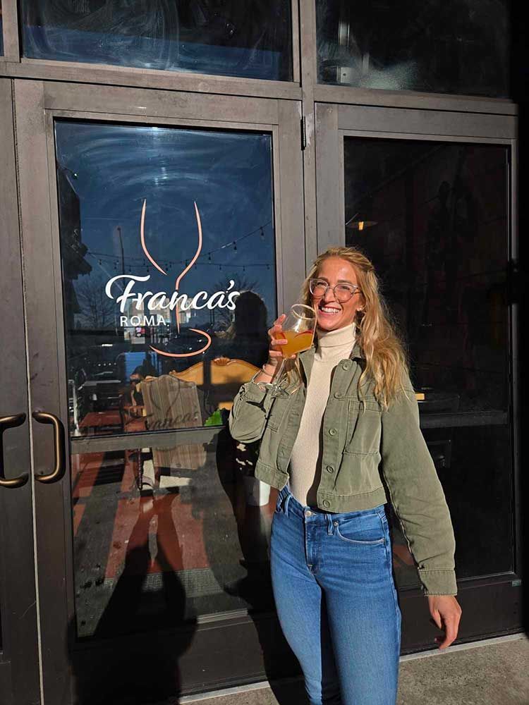 woman and wine by front door