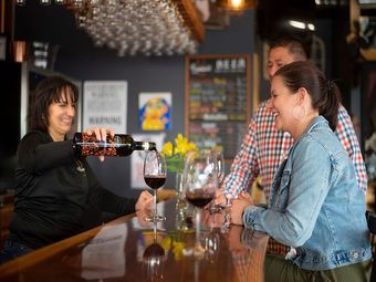 Bartender pouring red wine