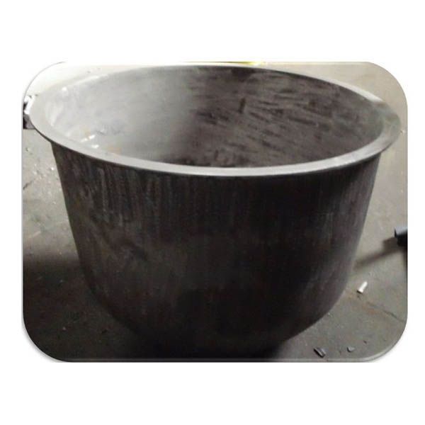 A large metal bowl is sitting on a table.