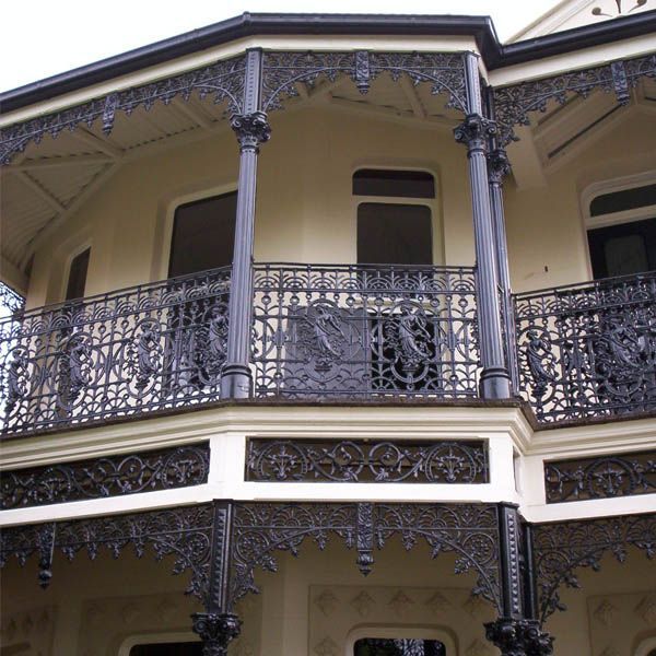 A house with a balcony and a wrought iron railing