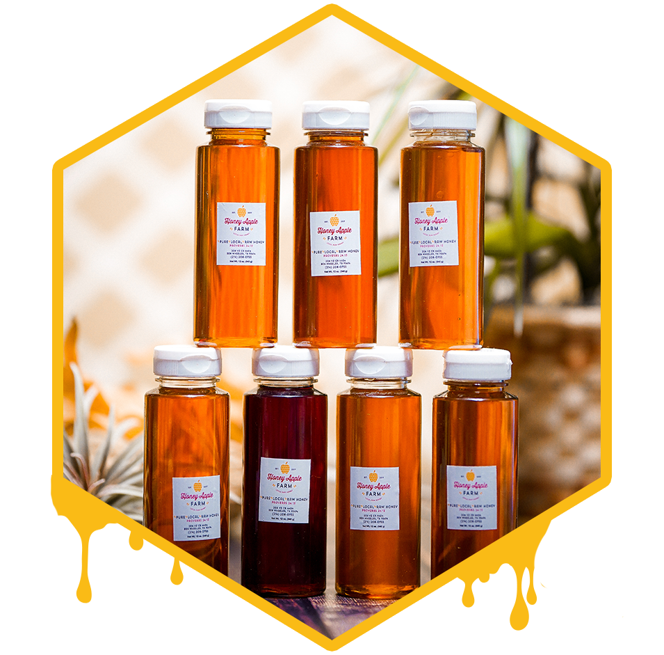 bottles of infused honey stacked on each other