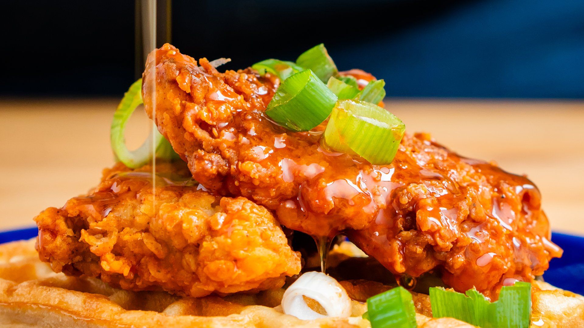 Hot Honey Oven Fried Chicken on a plate with green onions
