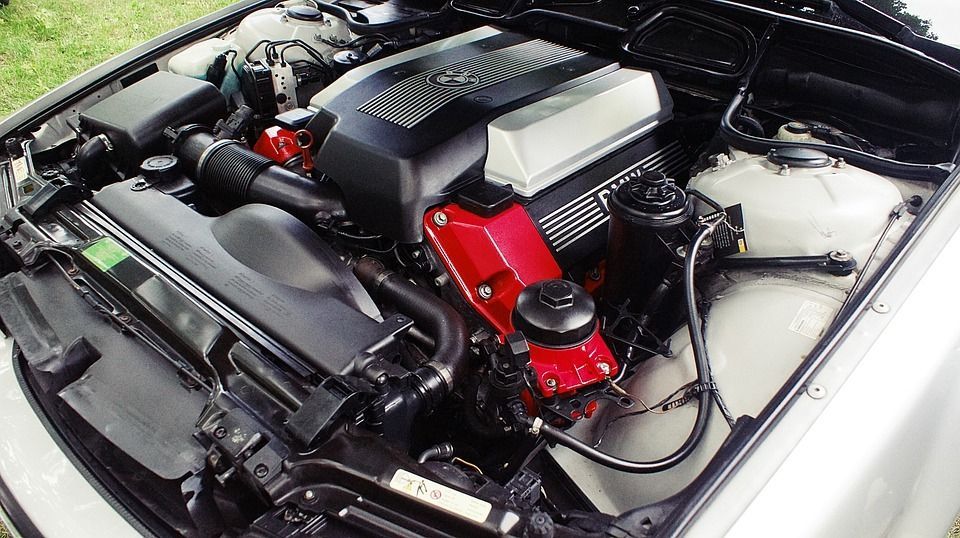 Clean BMW engine bay with black and red accents.