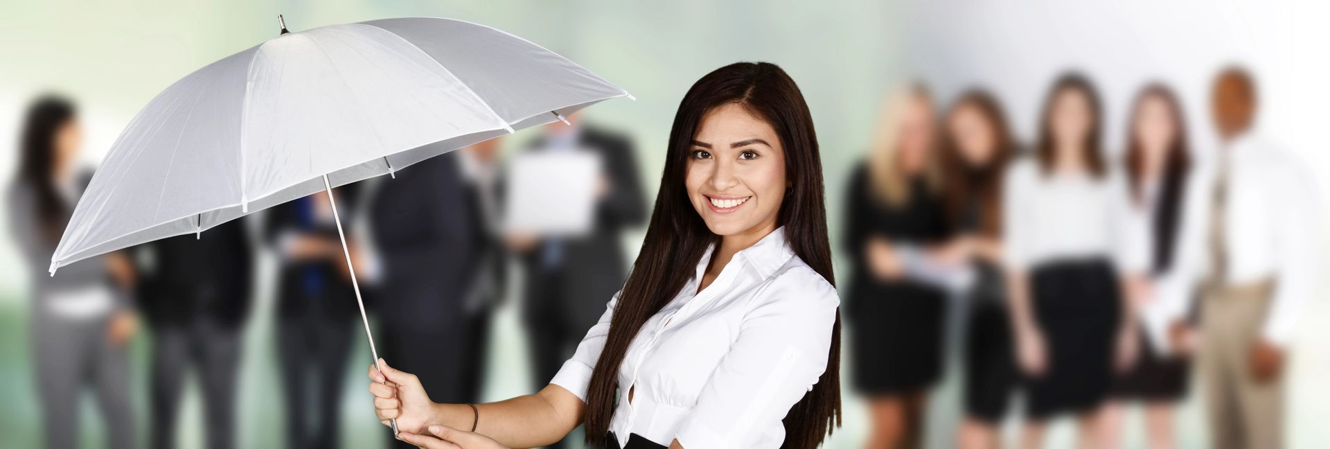 A woman is holding an umbrella in front of a group of people.