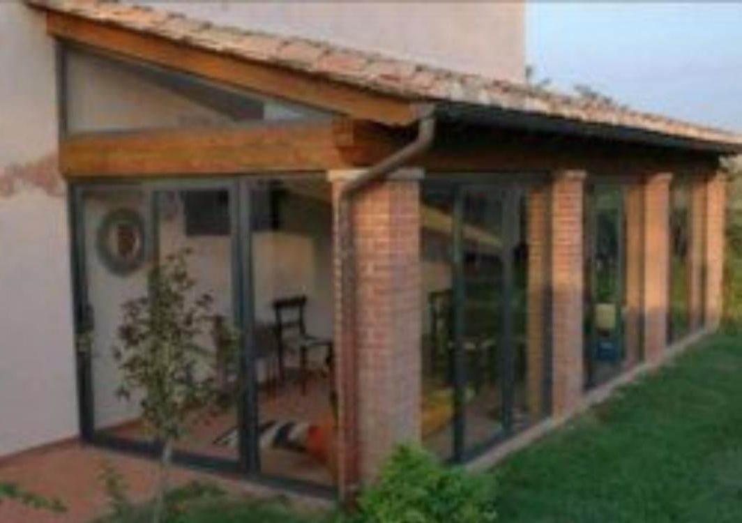 Una casa con molte finestre e un tetto di legno