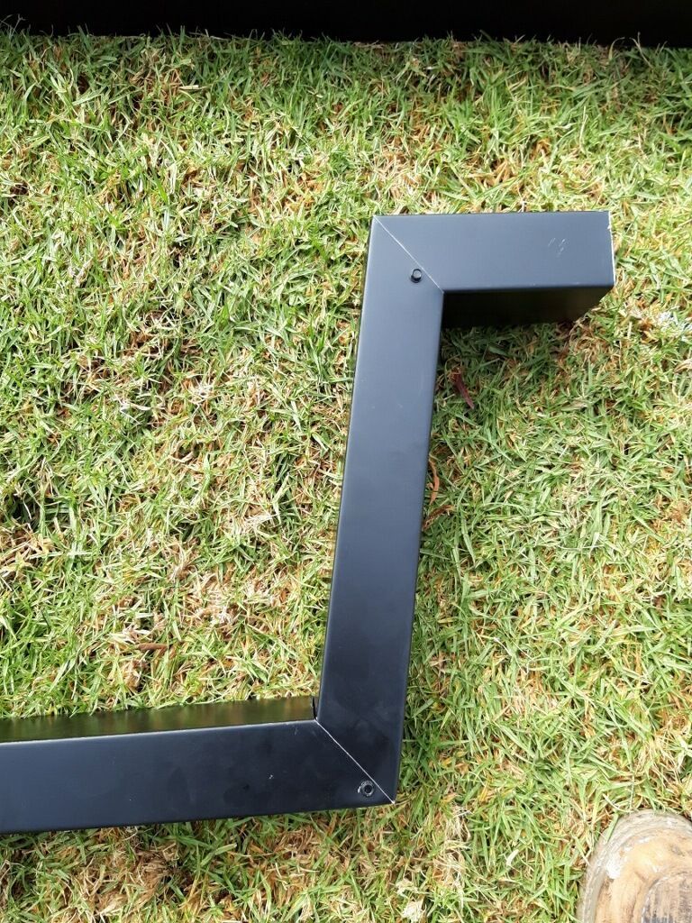 Black metal frame on green grass.