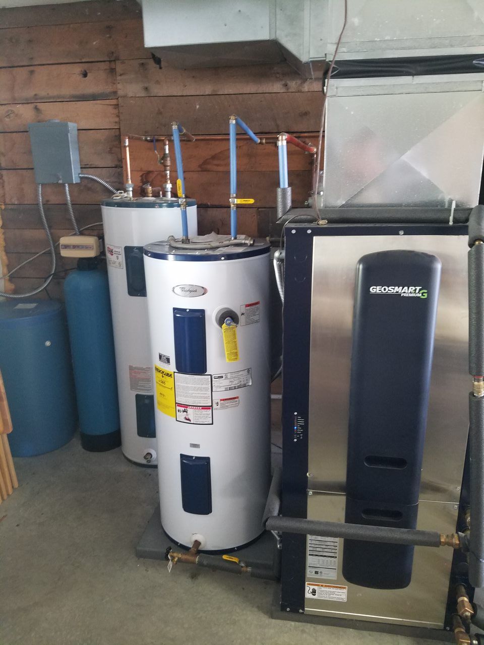 A row of water heaters are lined up in a room