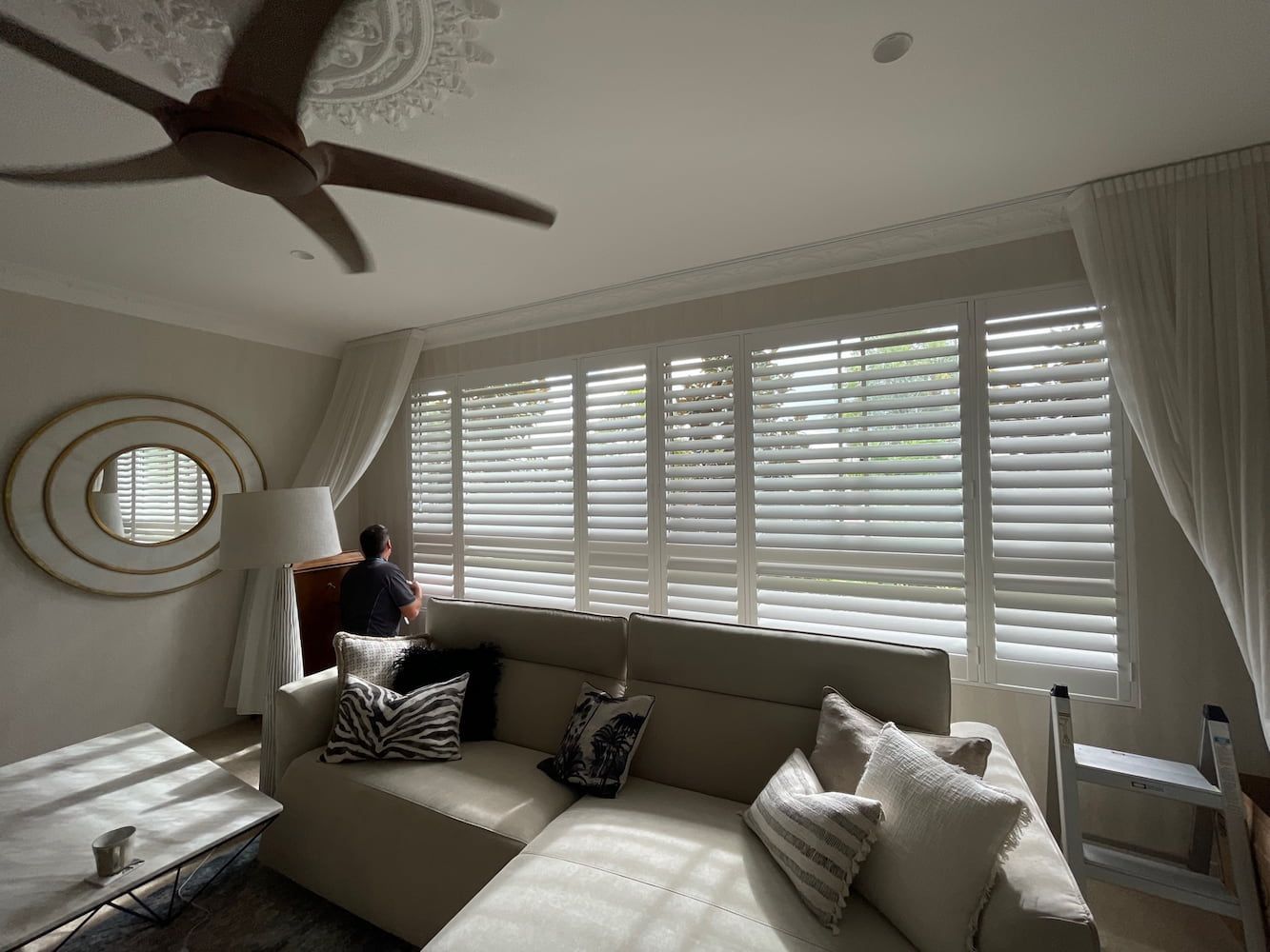 A Living Room With A Couch And A Ceiling Fan — Timeless Blinds And Shutters In Burleigh Heads, QLD