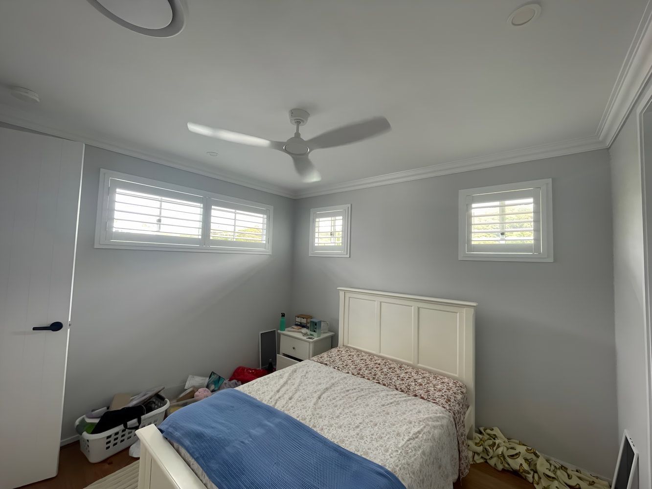 A Bedroom With A Bed And A Ceiling Fan — Timeless Blinds And Shutters In Burleigh Heads, QLD